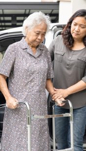 Help and support asian senior or elderly old lady woman patient walk with walker prepare get to her car, healthy strong medical concept.